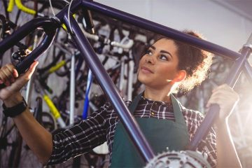 A woman is showing how to measure road bike size correctly