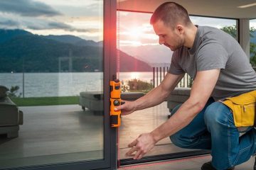 A man is showing how to measure sliding glass door in the house