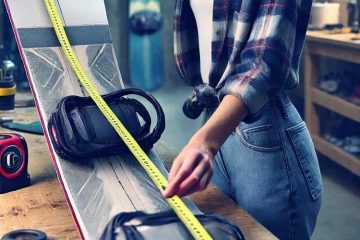 A girl with roulette are showing How to measure a snowboard