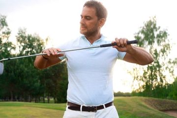 Man is showing how to measure golf club shaft length