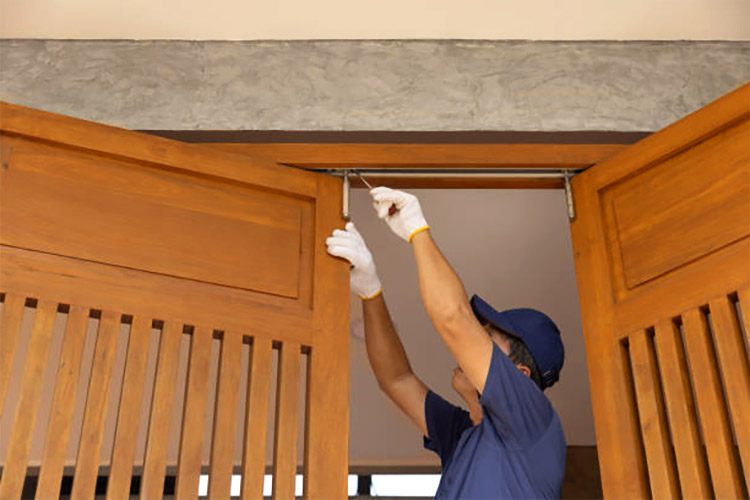 A man is showing how to measure for bifold doors