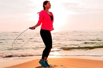 A woman on the beach is showing how to measure jump rope