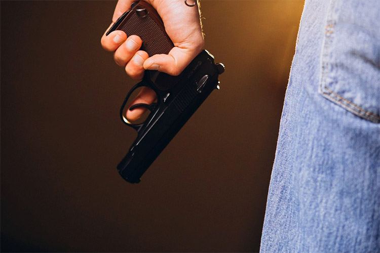 A man who is holding a pistol